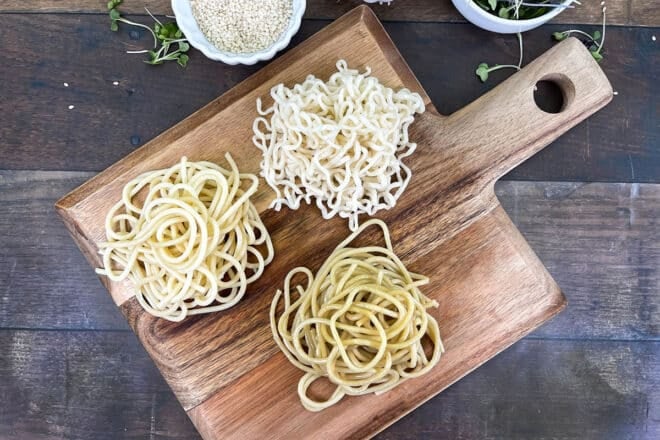 Three bowls of noodles, ramen noodles, regular spaghetti noodles, and spaghetti ramen noodles.