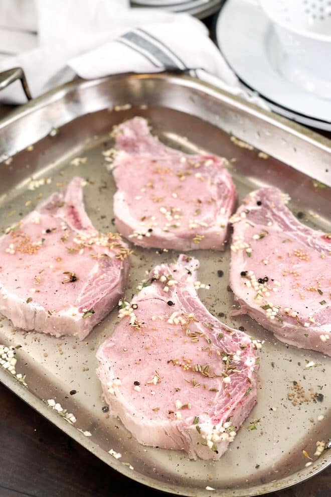 Raw bone-in pork chops in a brine