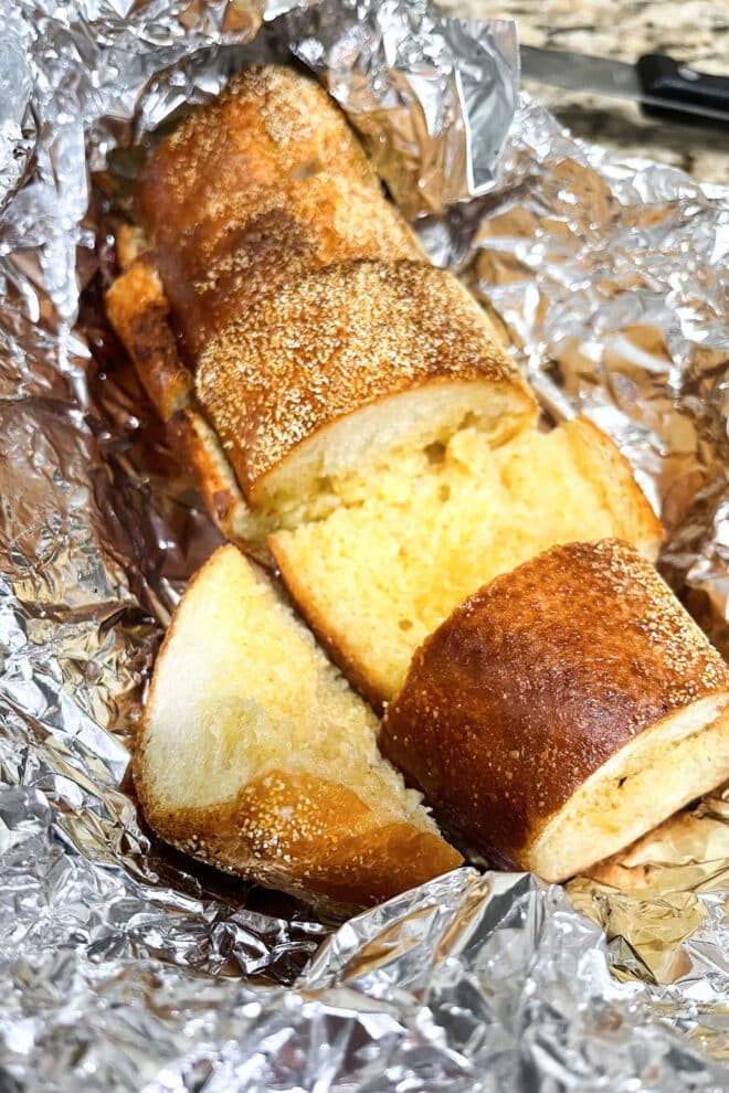 Buttery garlic bread on aluminum foil.