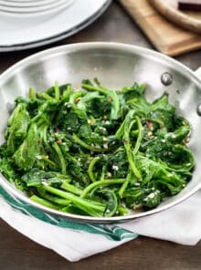 Sauteed garlic mustard greens in a stainless steel pan.