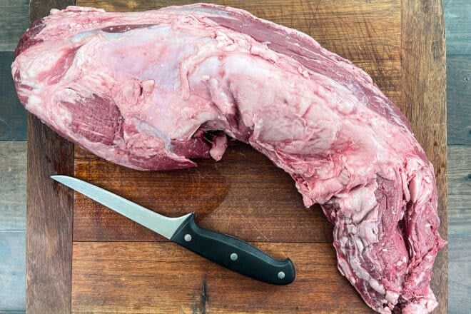 Whole untrimmed Beef Tenderloin on cutting board