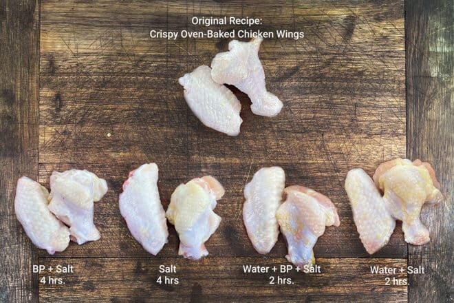 5 sets of uncooked chicken wings on a butting board, with labels identifying brine type.