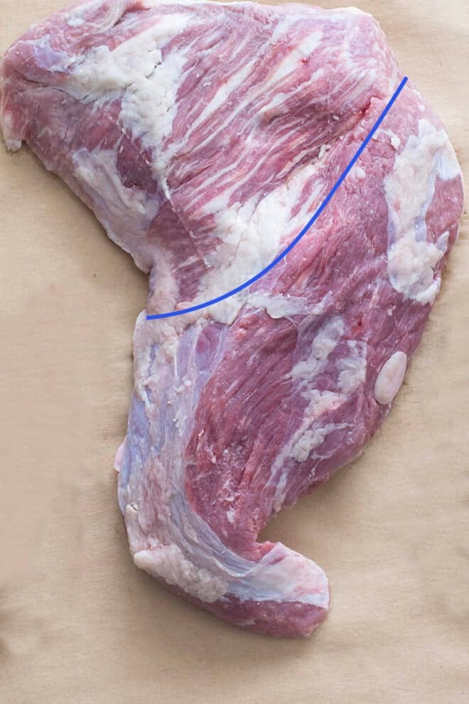 Photo of raw tri-tip steak and line showing initial cut to make.