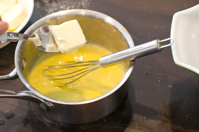 Adding softened butter to egg yolk mixture