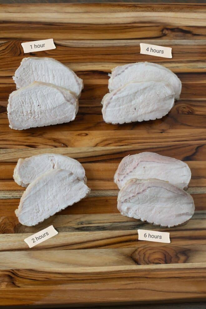 Slices from four brined and cooked pork loins on a cutting board.