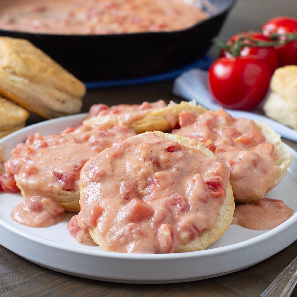 Plate of biscuits with Southern tomato gravy on top.