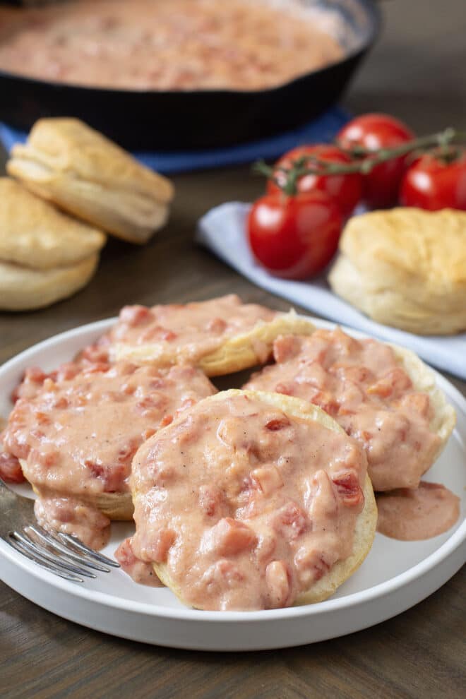Plate of biscuits with Southern tomato gravy on top.