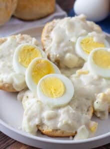Biscuits topped with creamy egg gravy and sliced hard boiled eggs.