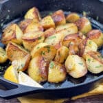 Cast iron pan of browned lemon potatoes.