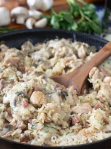 Pan of chicken and rice with mushrooms and melty Swiss cheese.