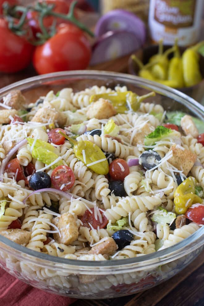 Glass serving bowl of Italian pasta salad.