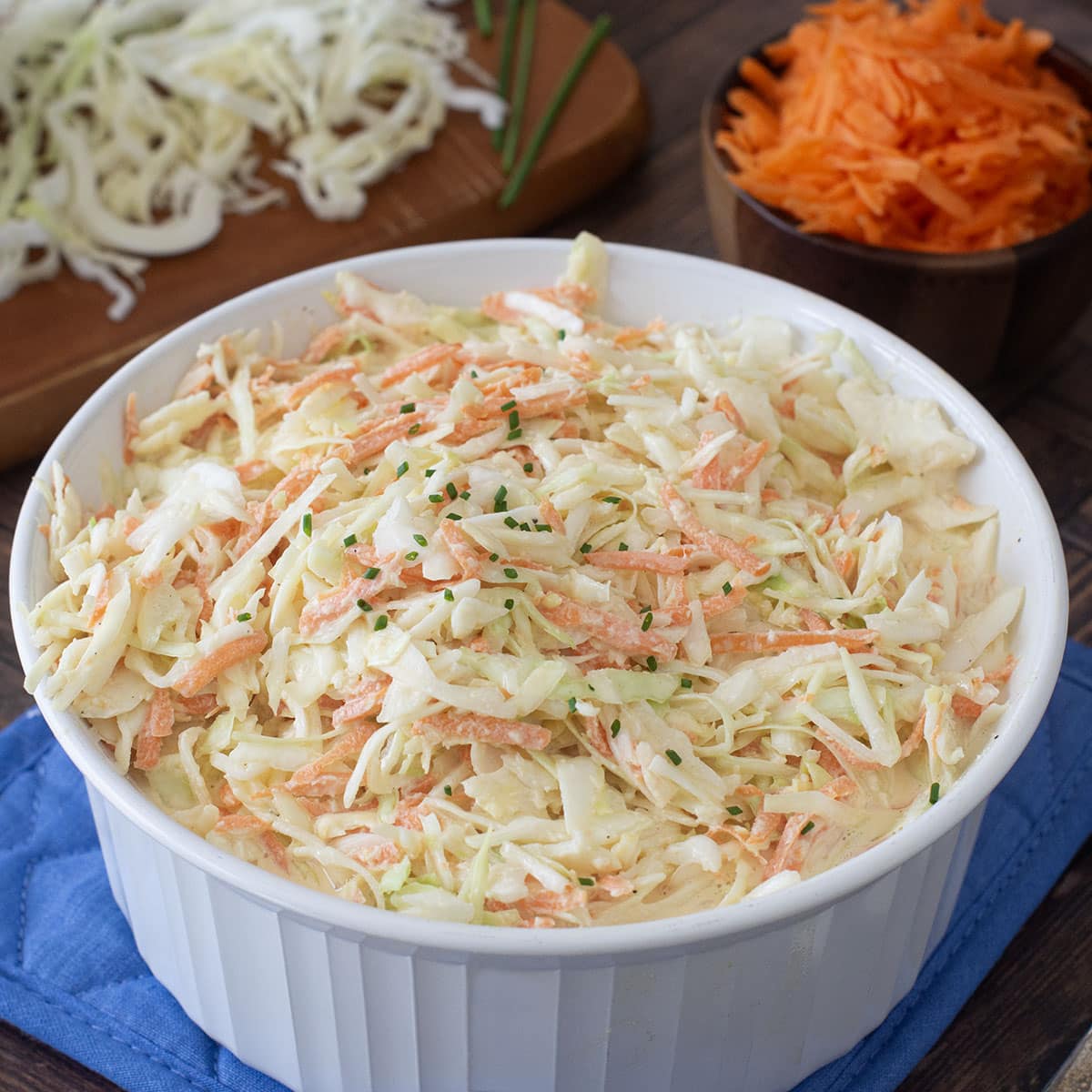Round white serving bowl with creamy coleslaw.
