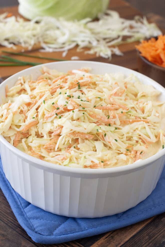 Round white serving bowl with creamy coleslaw.