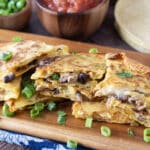 Slices of corn tortilla quesadillas with meat, black beans, and melty cheese.